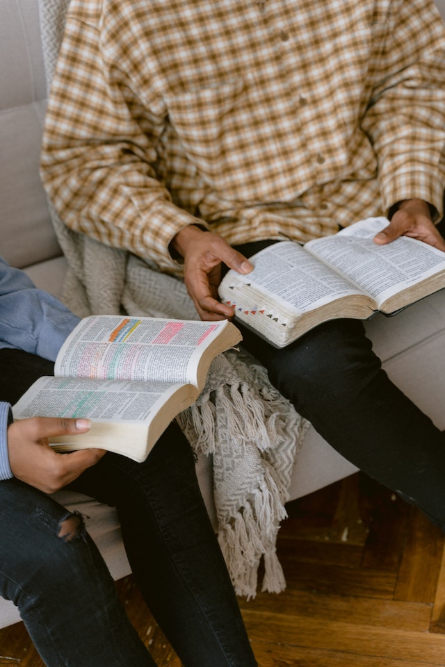 parents reading Bible with child